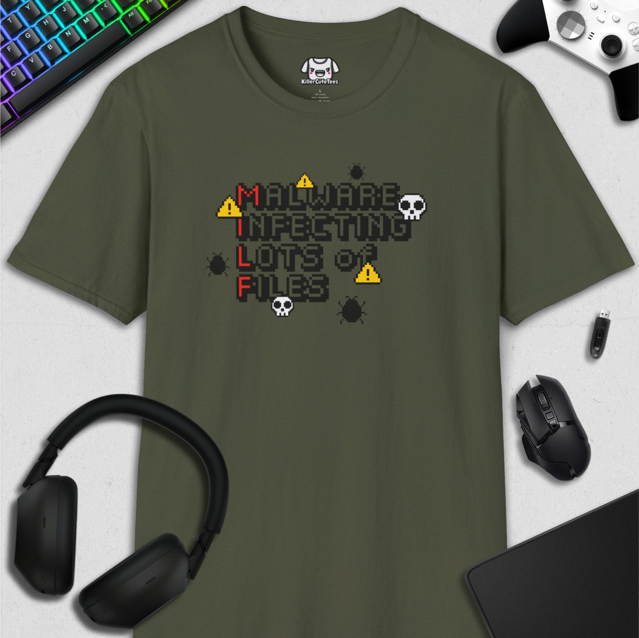 Green t-shirt with a graphic design on a white surface with computer accessories.