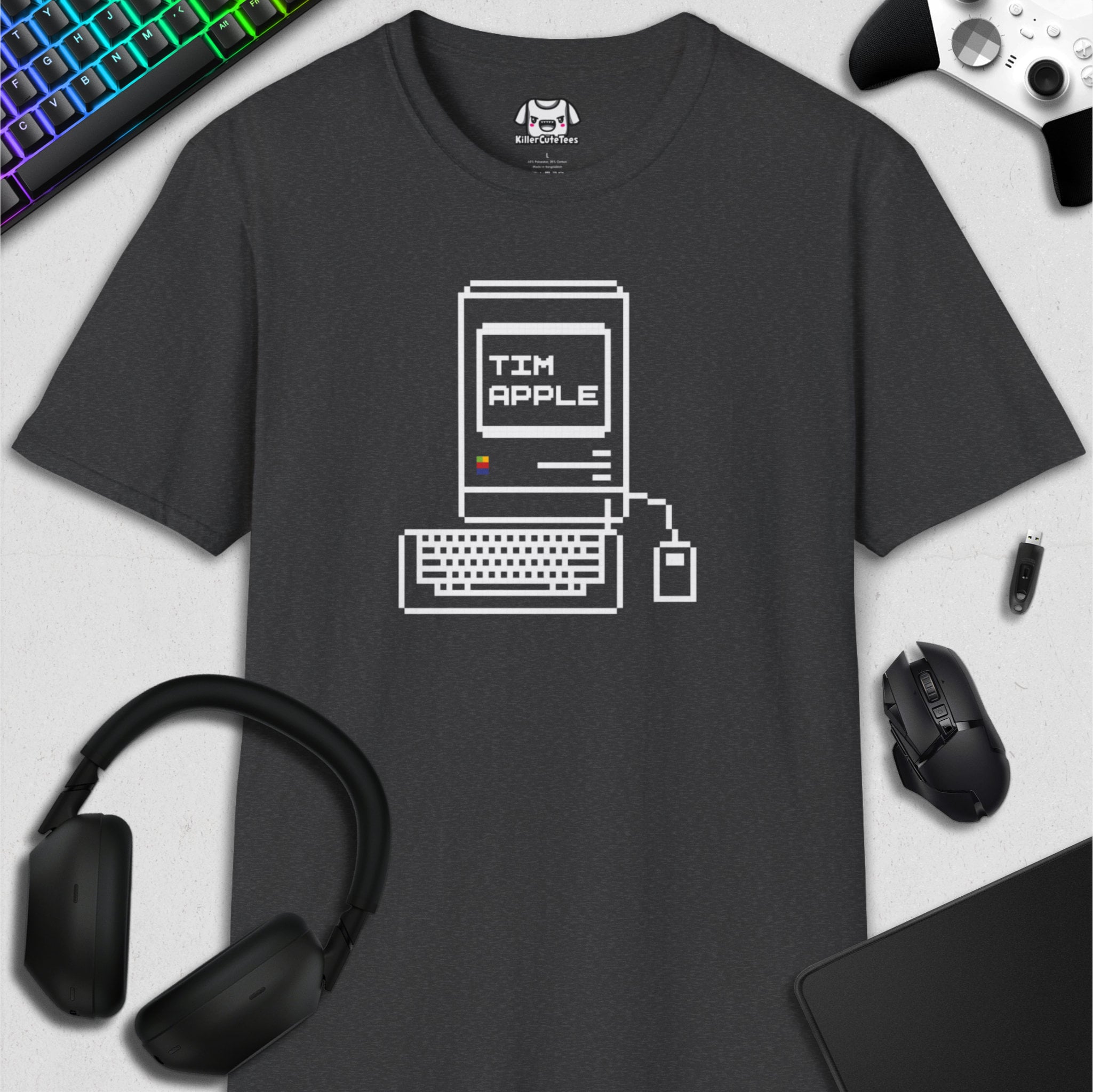 Black t-shirt with computer graphic design on a white surface with tech accessories.