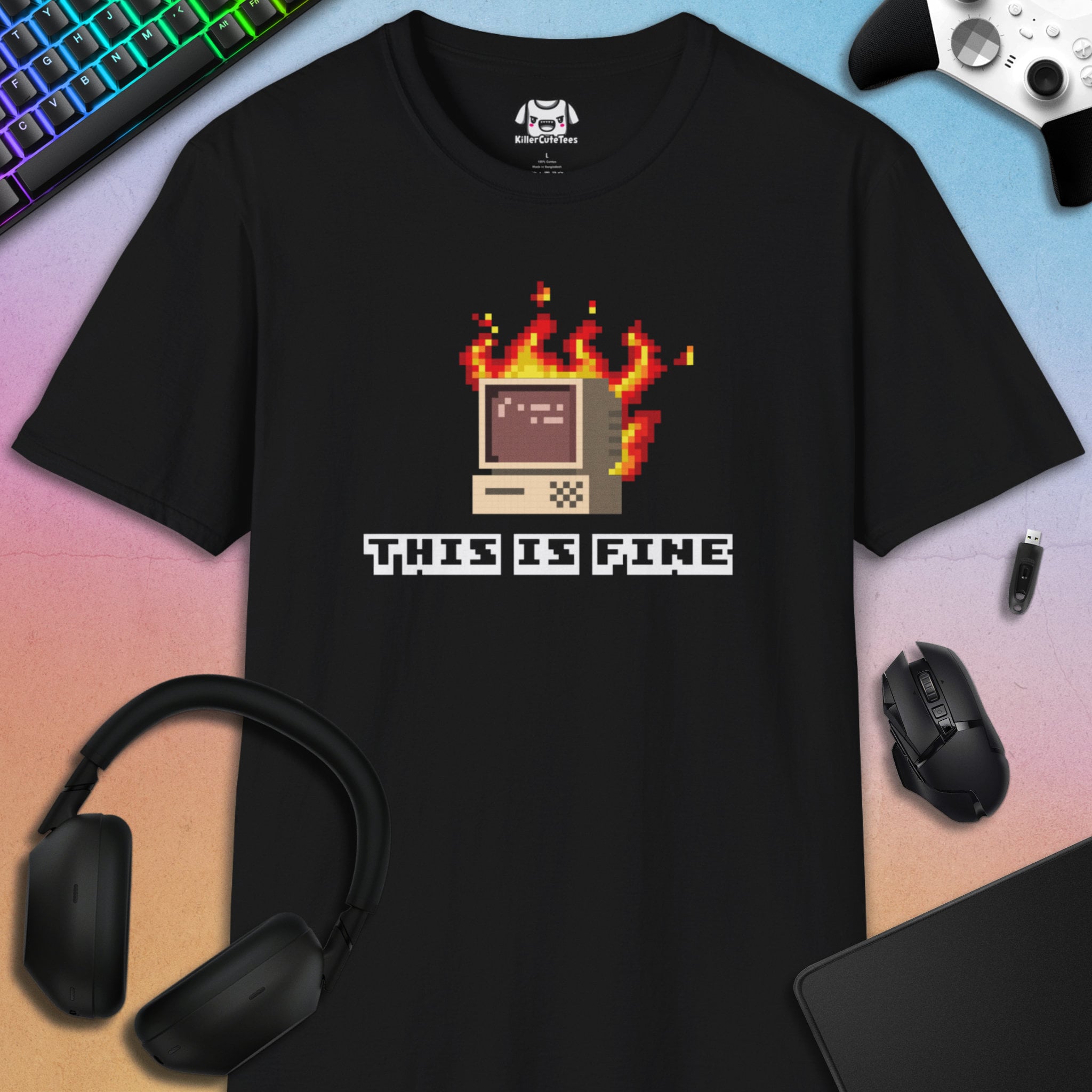 Black t-shirt with pixel art design and 'This is Fine' text on a colorful gradient background.