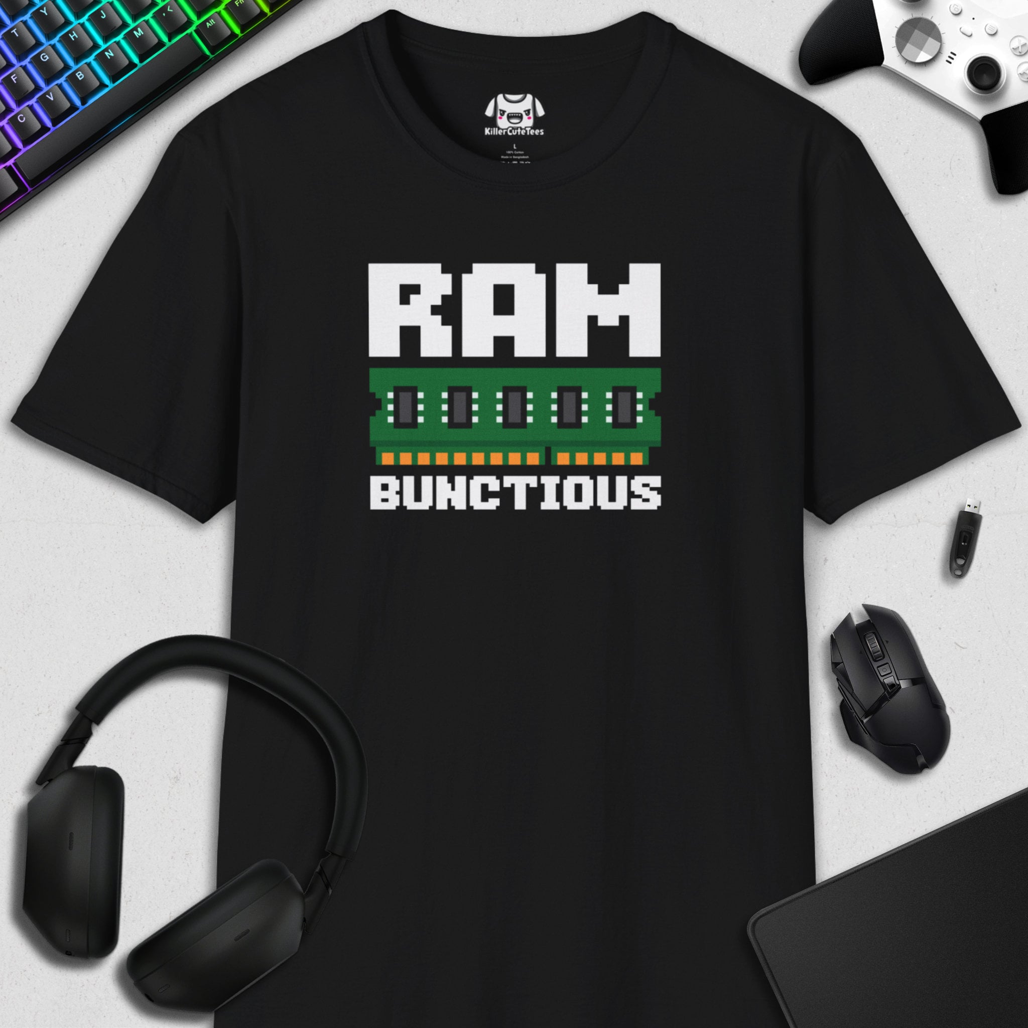 Black t-shirt with 'RAM BUNCTIOUS' graphic design on a desk with gaming accessories.