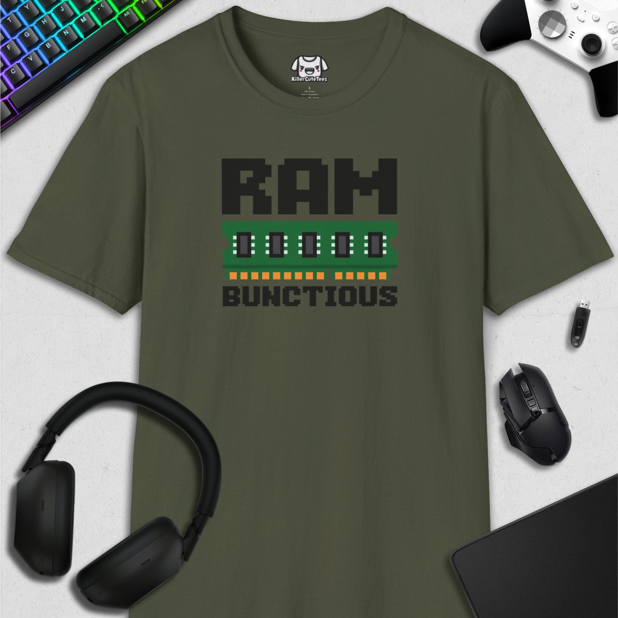 Green t-shirt with 'RAM BUNCTIOUS' graphic on a white surface with gaming accessories.