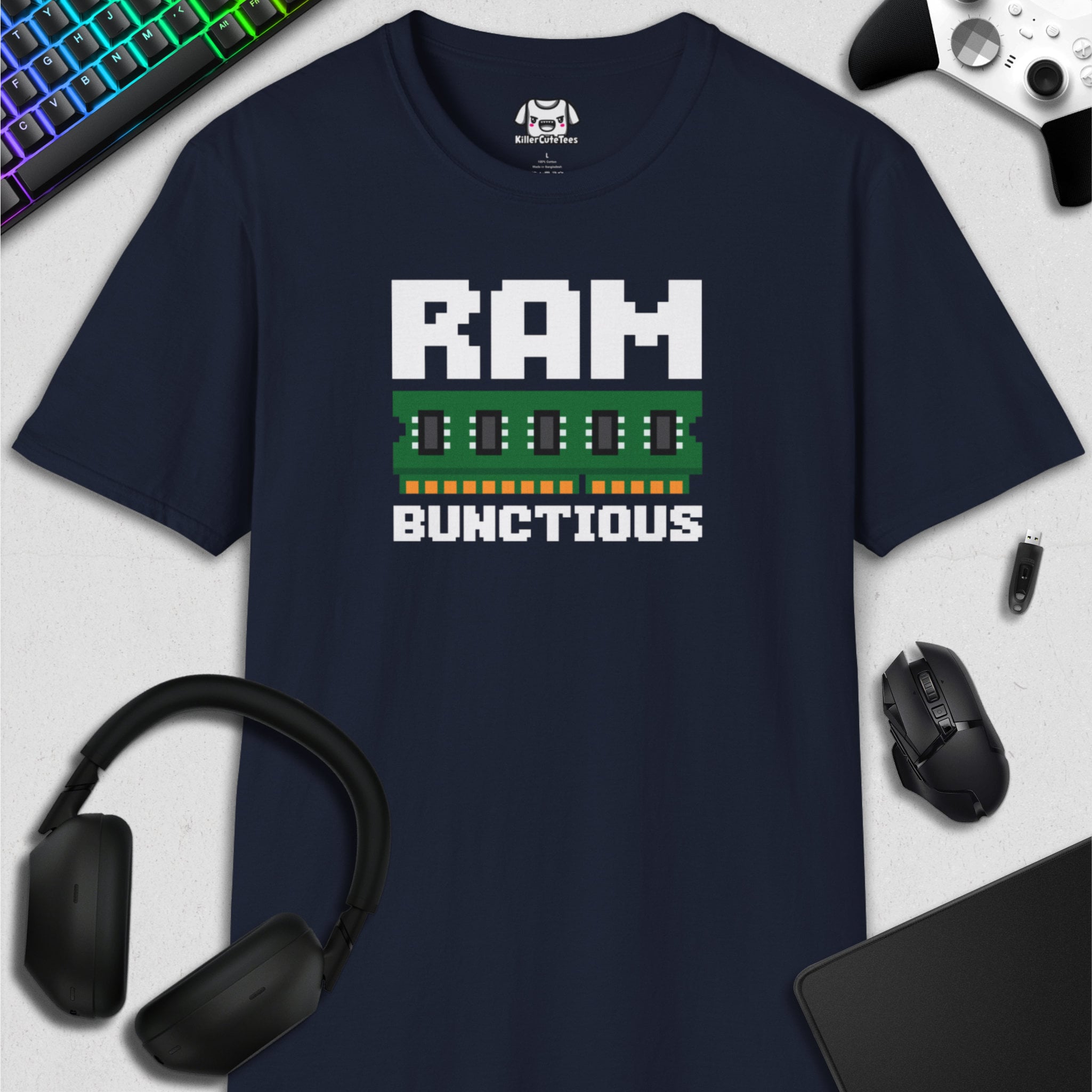 Navy blue t-shirt with 'RAM BUNCTIOUS' graphic design on a white surface with computer accessories.