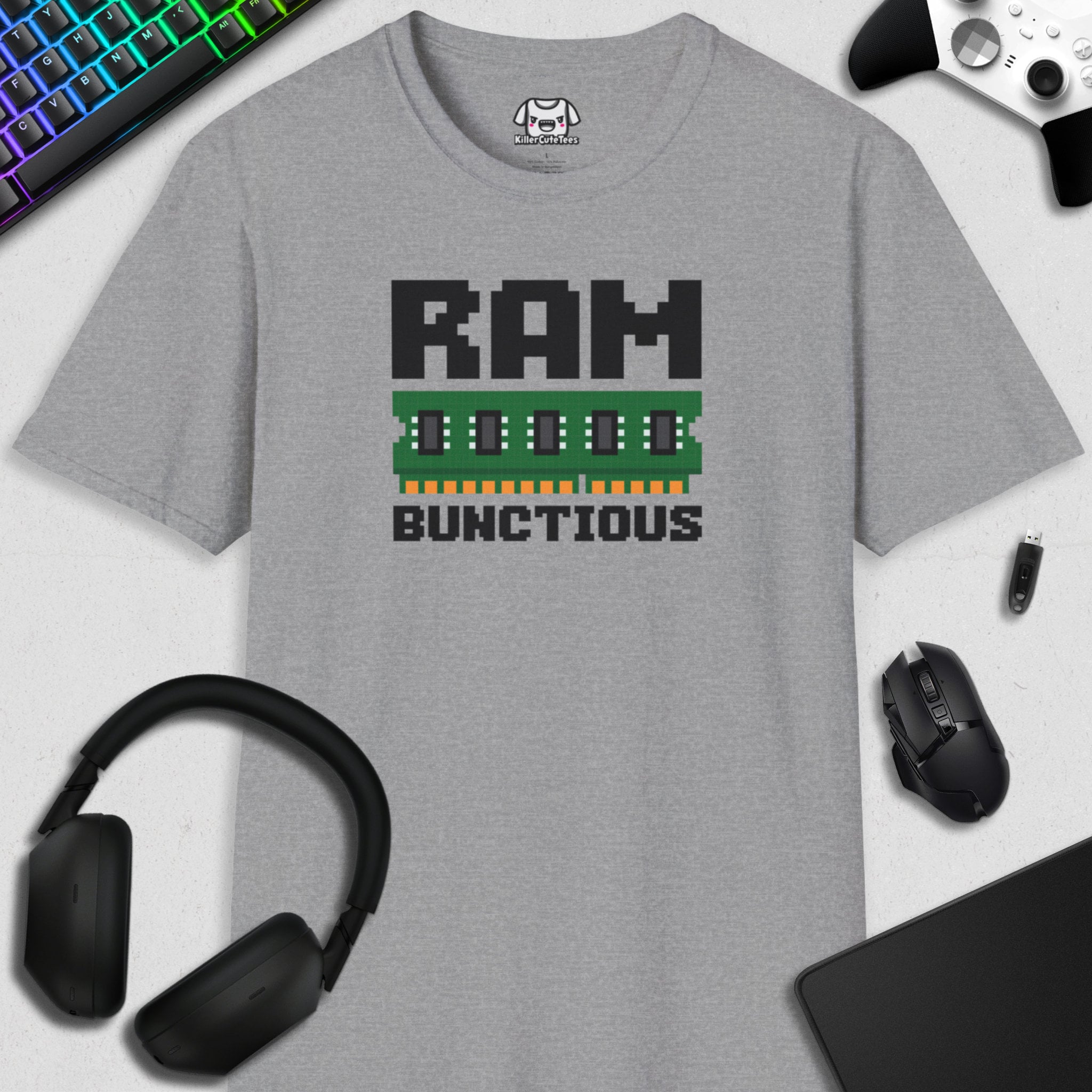 Gray t-shirt with 'RAM BUNCTIOUS' graphic design on a white surface with gaming accessories.